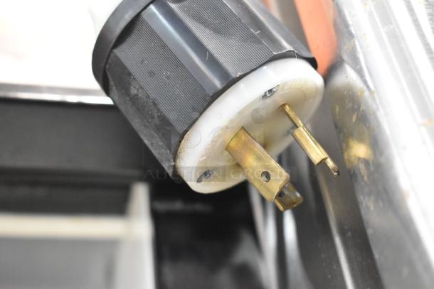 Close-up of a power plug for Turbo Air TOM-72E merchandiser, showing plug details. 220 Volts, 1 Phase.