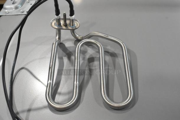 Brand new Blodgett 55127 safety valve and burner assembly, showing metal coils with wiring, ideal for industrial use.