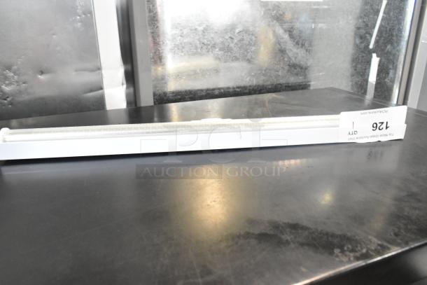 White LED light strip in original packaging, labeled with "126" and "QTY 1" tag, appears unused and in good condition.