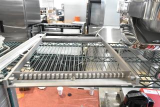 Brand new scratch and dent cutter on metal shelving, featuring stainless steel frame and cutting wires.