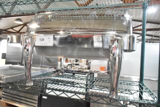 Brand new stainless steel chafing dish, minor scratches and dents, sturdy legs, reflective finish, auction tag visible.