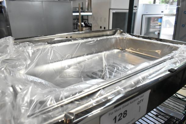 Brand new stainless steel chafing dish, scratch and dent condition, with protective plastic wrap.