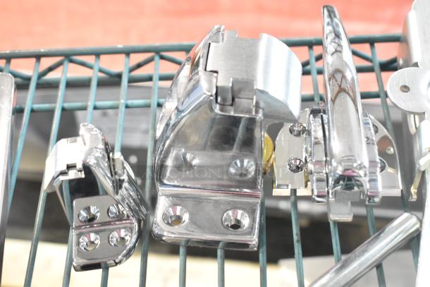 Four brand new scratch and dent hardware items including chrome hinges and door handle on a wire rack.