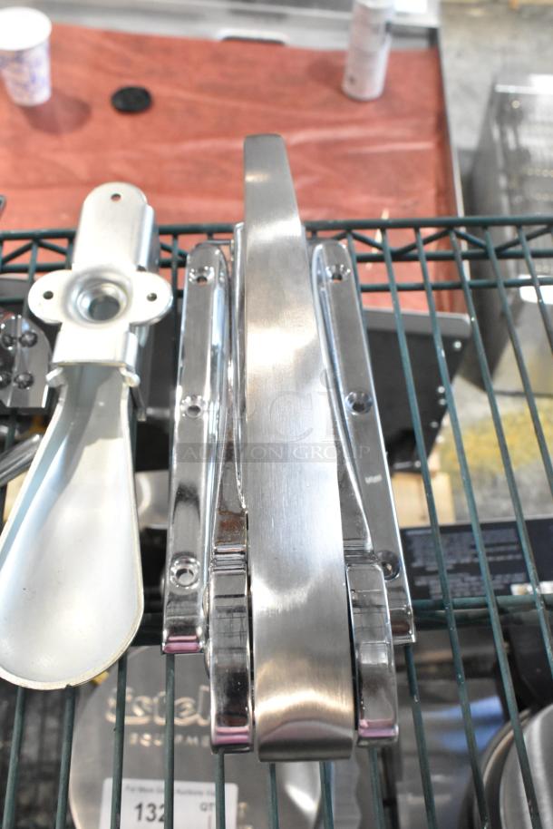 Brand new set of scratch and dent items including a silver hinge and door handle displayed on a wire rack.