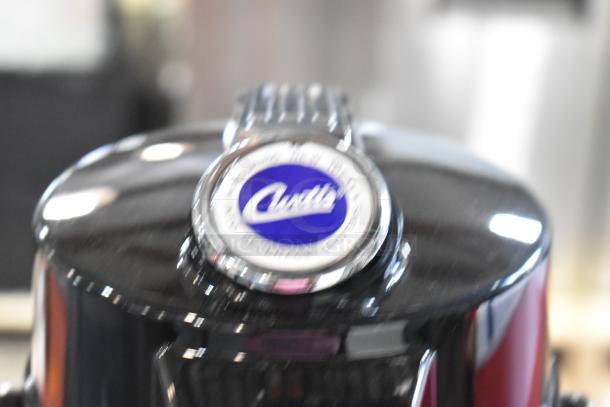 BRAND NEW SCRATCH AND DENT Curtis stainless steel air pot, blue Curtis logo, durable build, slight exterior blemishes.