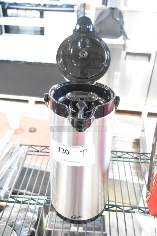 BRAND NEW Curtis stainless steel air pot; minor scratch and dent. Features a durable design with an open lid. Tag shows auction details.