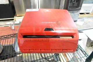 Red Georgia Pacific enMotion wall-mounted paper towel dispenser, new with minor scratches. Features automatic dispensing.