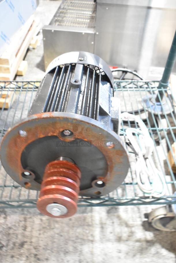 BRAND NEW Y100L2-6 motor, scratch and dent condition, visible rust on casing, intact wiring, labeled specifications tag.
