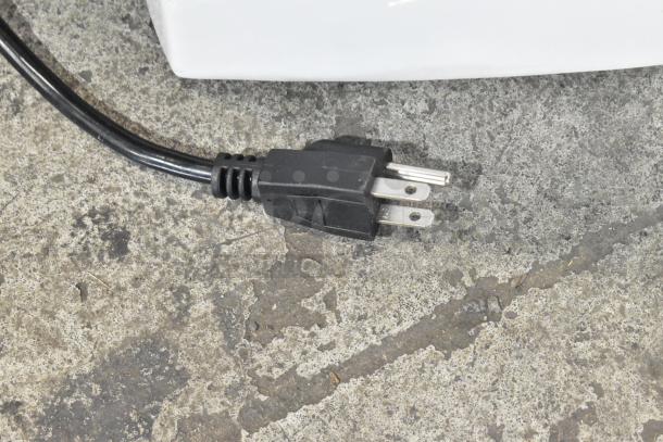 Power plug of a Varimixer V5A commercial countertop mixer on a concrete surface.