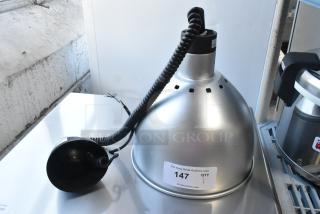 Brand new ServIt 423HLR85CH retractable cord ceiling mount heat lamp with chrome finish dome. Model label visible.