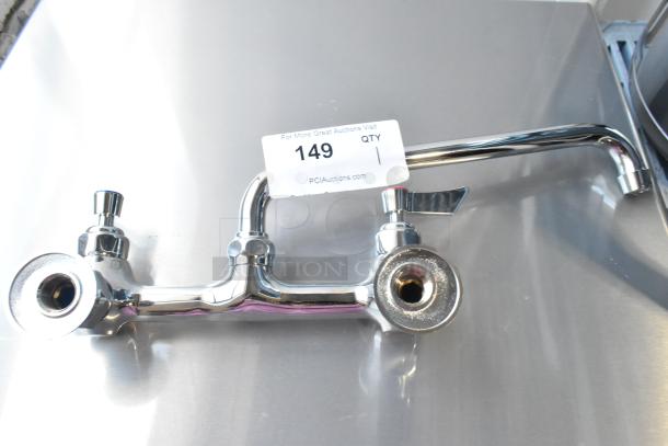 Brand new chrome faucet with handles, scratch and dent condition, model tag "149" visible, ready for installation.