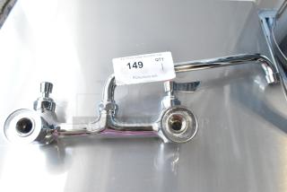 Brand new chrome faucet with handles, scratch and dent condition, model tag "149" visible, ready for installation.
