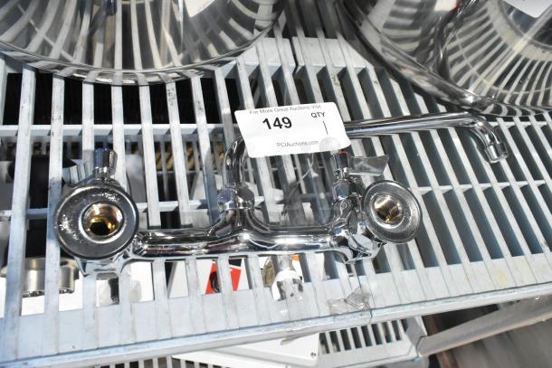 Brand new chrome faucet with handles, minor scratches and dents, auction tag indicates item 149.