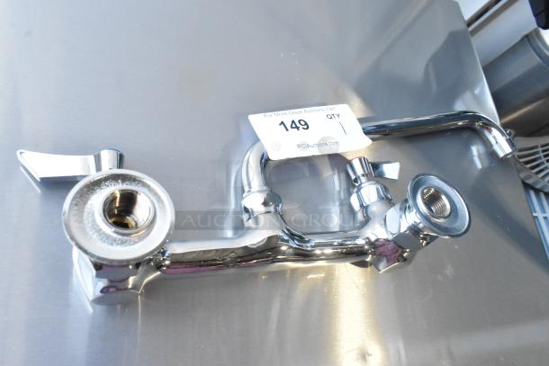 Brand new chrome faucet with handles, labeled "Scratch and Dent," condition visible, auction tag with number 149.