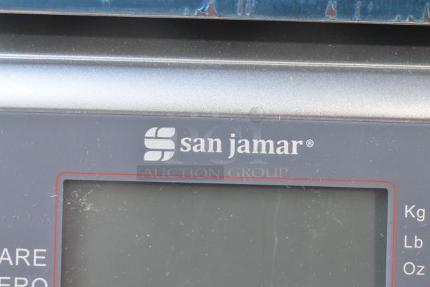 San Jamar SCDGM33 digital scale, 33 lb capacity, brand logo and display panel shown, scratch and dent condition.