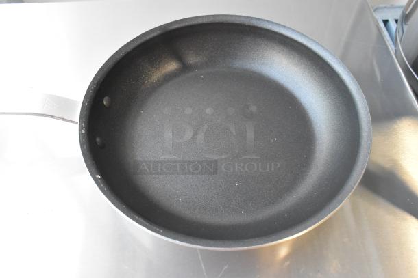 6 Vigor 473ALFP10EPH 10" aluminum fry pans, non-stick Eclipse coating, plated handle, new with minor scratches.