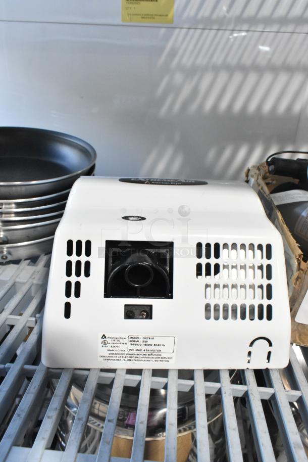 Brand new American Dryer GXT9-M ExtremeAir, white steel cover, 100/240V, automatic, scratch and dent condition. Model label visible.