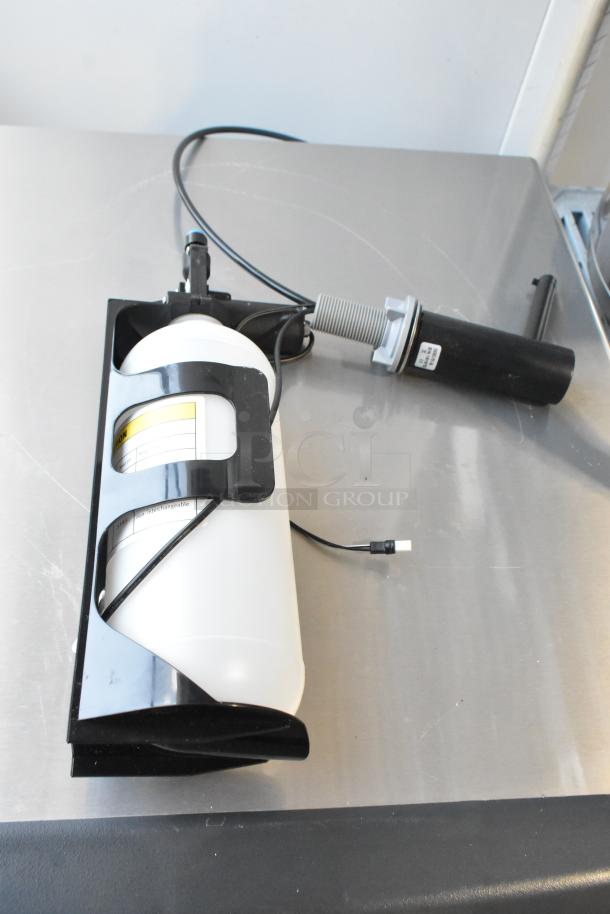 Brand new Delta DESD-751-BL electronic soap dispenser in matte black, deck mount, visible wiring, minor scratches.