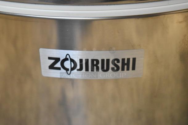 Brand new Zojirushi RDS-600 stainless steel sushi rice container, 66 cup capacity, visible scratches on surface.
