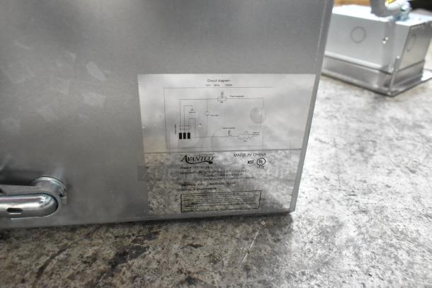 Brand new Avantco 177TM12B hot food well with round corners, drain, labels showing 208V, 1 Phase, slight dents visible.
