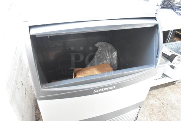 BRAND NEW 2024 Scotsman UC2024SA-1A stainless steel undercounter ice machine, 227 lb capacity, shown with open compartment.