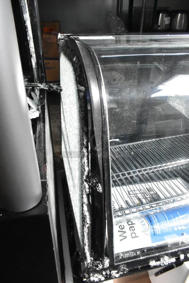 Brand new Avantco 360BCC28HCB 27.5" black refrigerated bakery display case with LED lighting, showing exterior damage.
