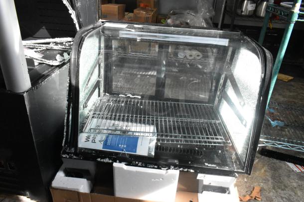 Brand new Avantco 360BCC28HCB 27 1/2" black refrigerated bakery display case with LED lighting, 120V, minor scratches.
