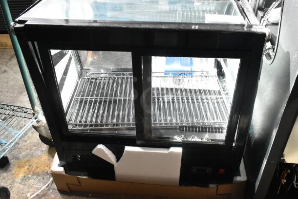 Brand new Avantco 360BCC28HCB 27.5" black refrigerated bakery display case, scratch and dent, LED lighting, 120V, 1 phase.