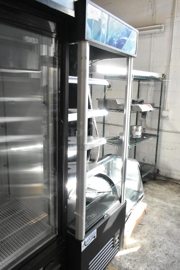 Brand new Avantco 189BVAC28HC 28" black refrigerated air curtain merchandiser with broken glass and commercial casters.
