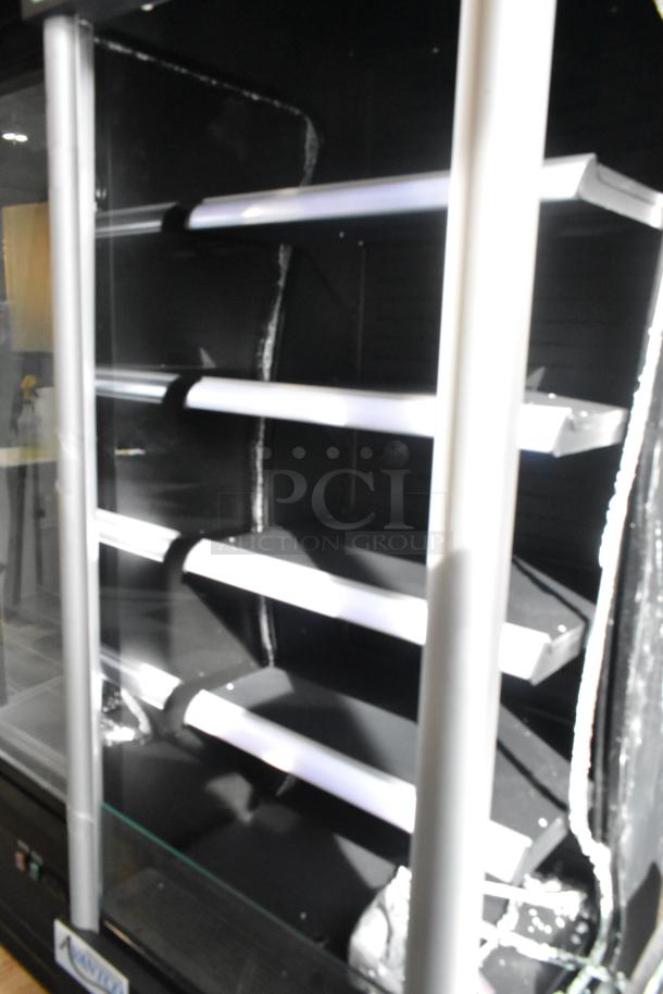 Brand new Avantco 28" refrigerated air curtain merchandiser, model 189BVAC28HC. Black, on commercial casters. Notable scratch and dent; broken glass visible.