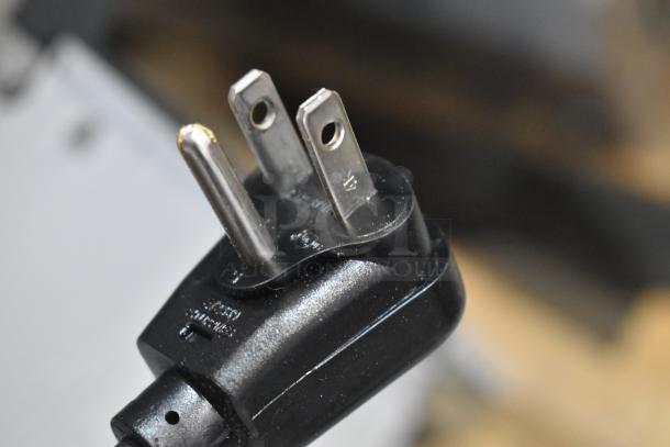Close-up of the power plug for Scotsman HID525AB-1A commercial ice machine, showing a standard three-prong connection.