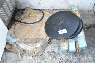 Lot of 8 items including Lancaster Table & Seating 17" round cast iron table base plate, shown with packaging and flat boxes.