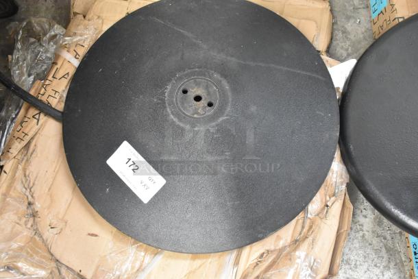 Lot of 8 items, featuring Lancaster 17" round cast iron table base plate. Visible label: "172 QTY." Minor scratches.