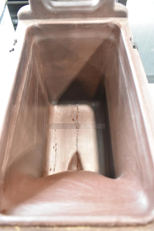 Brand new Cambro brown poly beverage holder with minor scratches, showing interior. Ideal for catering, durable build.