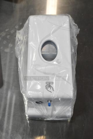 Cambro White Poly Wall Mount Hand Sanitizer Dispenser, new scratch and dent, in plastic wrap, hand symbol visible.