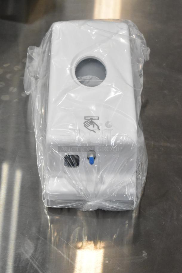 Cambro white poly wall mount hand sanitizer dispenser, brand new with minor scratches, in protective plastic wrap.