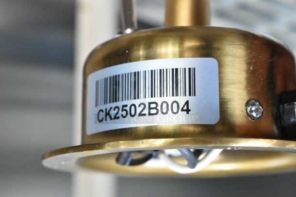 Cambro CK2502B004 warming lamp, gold finish, 115 volts, 1 phase, brand new with minor scratches, barcode visible.