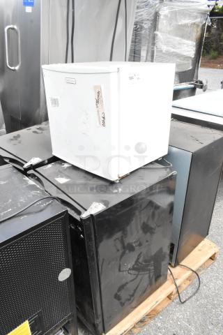 Six assorted mini coolers and water cooler bases on a pallet, including Primo, Emerson, Galanz, Black & Decker, and GE models.