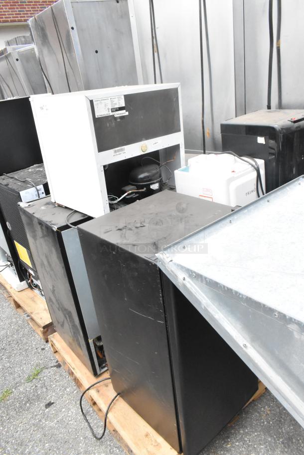 Six mini coolers and water cooler bases, including Primo and Emerson models, on a pallet. Visible wear on surfaces.