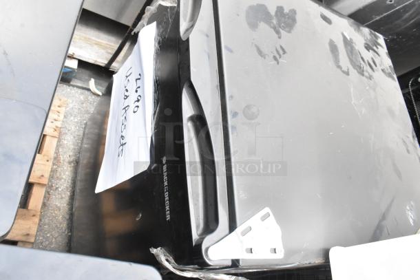 6 used items including Black & Decker cooler, shown with label. Scratches visible on surface. Multiple coolers in lot.