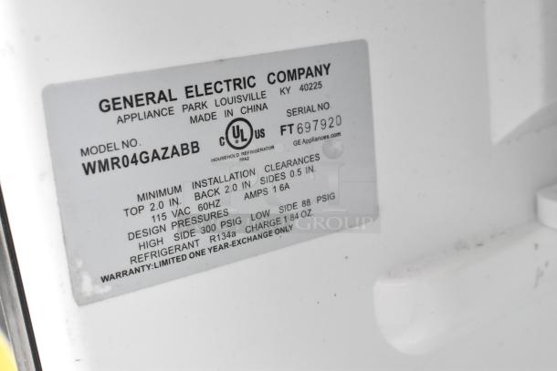 GE mini cooler model WMR04GAZABB label, indicating specs: 115 VAC, 60Hz, 1.6A, made in China. Limited one-year warranty.