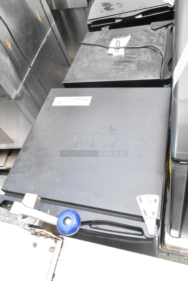 Four items including Arctic King ARM32D5ABB cooler, US-KC1007BK freezer, Galanz GL46TS5E cooler, Black & Decker BCF32V cooler. Each has visible use and labels indicating used market condition.