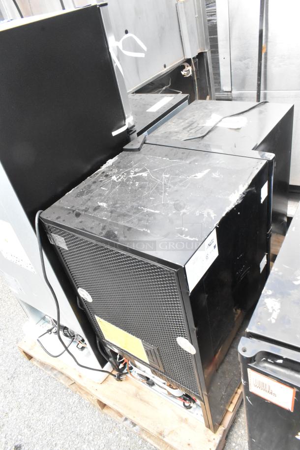 Four coolers and freezers on a pallet, including Arctic King ARM32D5ABB, US-KC1007BK, Galanz GL46TS5E, Black & Decker BCF32V. Mixed condition, some visible wear.