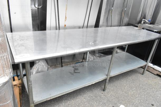 Stainless steel table with mounted commercial can opener, metal under shelf, good condition, perfect for commercial use.