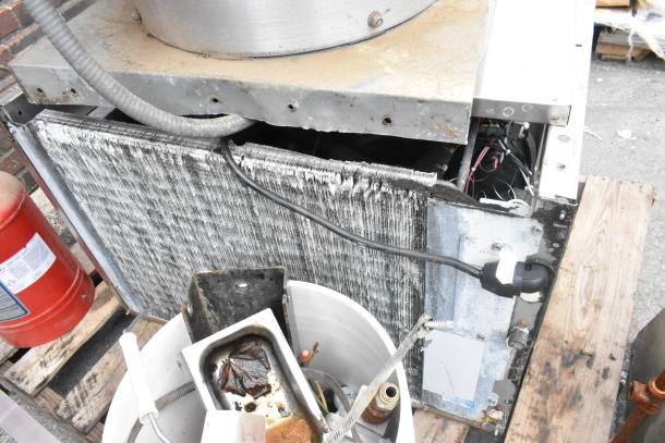 4 items: VXD33 metal mushroom exhaust hood, fire suppression tank with label, ice head, assorted kitchen parts. Mixed condition.