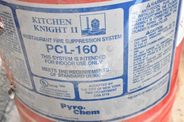 Kitchen Knight II PCL-160 fire suppression tank label, detailing safety standards and indoor use. Signs of wear visible.
