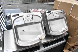 2 new Elkay EZSDWS_1G metal wall mount water fountains, 115V, 1 phase, slight scratch and dent. Auction label visible.