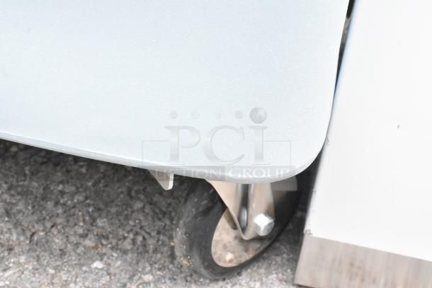 BRAND NEW Metro PCD Blue Poly Dish Cart on commercial casters, showing caster detail; slight scuffs visible.