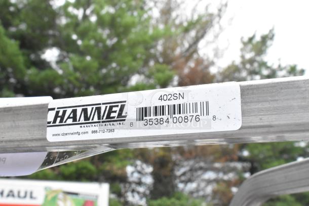 Brand new Channel 402SN 15 pan end load stainless steel bun rack with commercial casters, tag shows model and barcode.