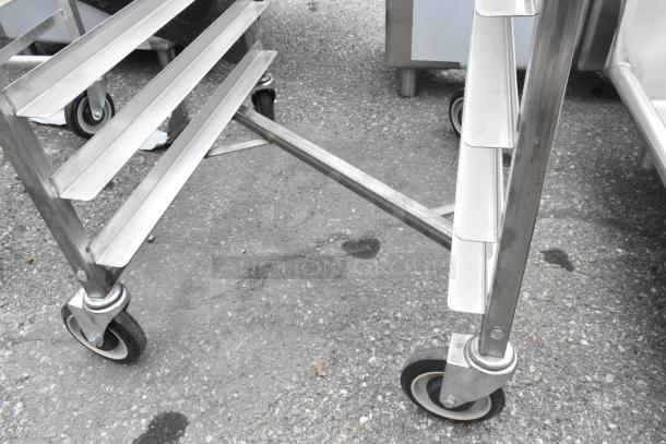 Brand new Channel 402SN 15 pan end load stainless steel sheet pan rack, visible scratch, on commercial casters.